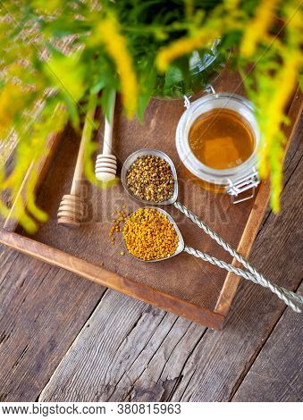 Bee Pollen Granules. Fresh Oney On Wooden Table. Still Life Bee Product Background. Wooden Spoon Wit