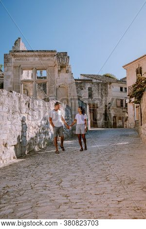 Couple Visit The Town Of Les Baux De Provence France, Old Historical Village Build On A Hill In The 