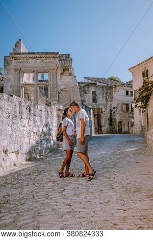 Couple Visit The Town Of Les Baux De Provence France, Old Historical Village Build On A Hill In The 