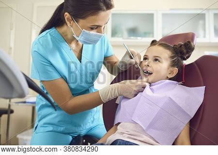 Little Girl At A Pediatric Dentist With Mask And Gloves Service Child Tooth Care In A Dental Dentist