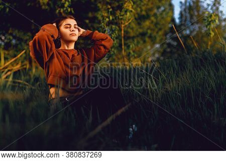 Portrait Of Beautiful Young Woman In The Sun Flare
