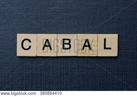 Gray Word Cabal From Small Wooden Letters On A Black Table