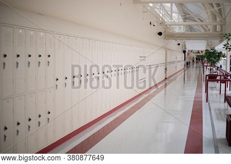 Beige School Lockers In Empty High School Hallway