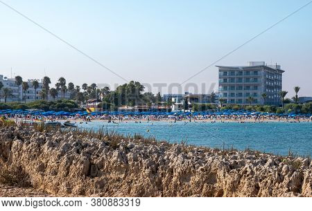 Ayia Napa, Cyprus - August 6 2020: Tropical Beach With Turquoise Water And Crowded With Tourists Swi