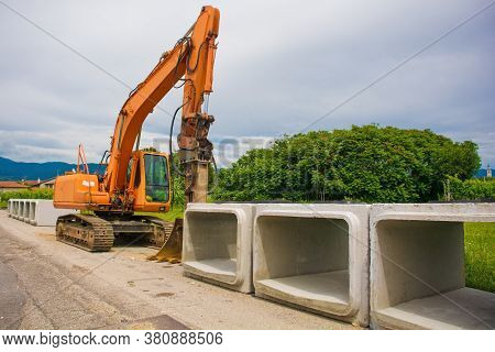 A Crawler Excavator With A Rotating House Platform And Continuous Caterpillar Track With Some Reinfo