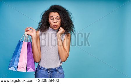 Attractive Young Dark Skinned Woman With A Bunch Of Shopping Bags Worried She Couldnt Stop Buying. S