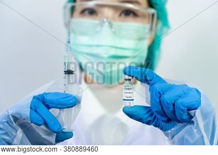 Doctor, Scientist, Researcher Hand In Blue Gloves Or Protective Suit Preparing For Human Clinical In