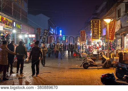 Luoyang, Henan Province / China - January 3, 2016: Lively Luoyang Old Town District At Night, With T