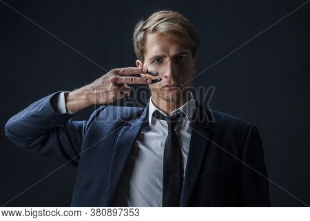 Businessman Draws Two Stripes On His Cheeks, War Paint. Competition In Business, Concept. A Young Ma