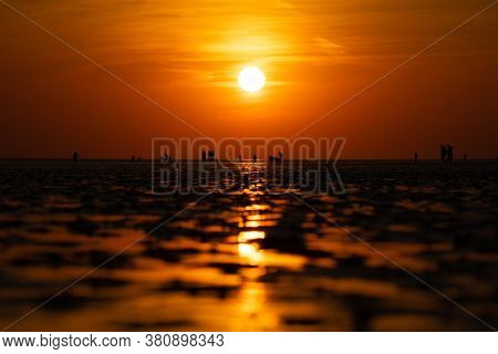 People On The Beach In The Sunset Off Buesum In The Wadden Sea.