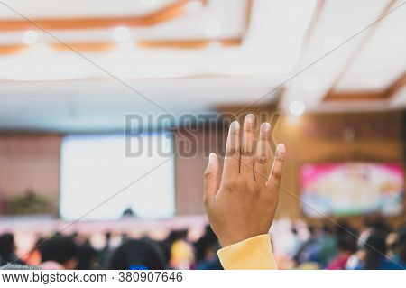 Audience Raising Hand While Speaker On Stage At Conference To Answer Question While Speaker Speech A