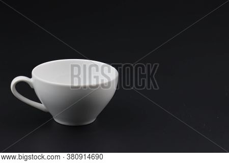 Empty white coffee cup on black color background