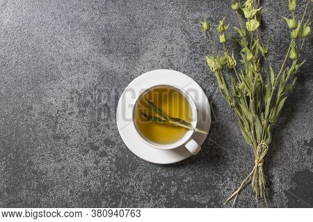 White Cup Of Herbal Sage Tea With Dried Sage Leaves On Grey Rustic Background. Herbal Tea Hot Drink 