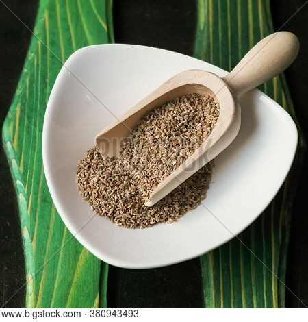 Ajwain Spice In A White Plate And A Wooden Scoop In It