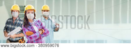Female and Male Contractors In Hard Hats Wearing Medical Face Masks At Construction Site During Coronavirus Pandemic Banner.