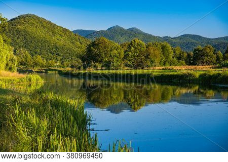 Beautiful Gacka River Flowing Between Green Fields, Summer View, Lika Region Of Croatia