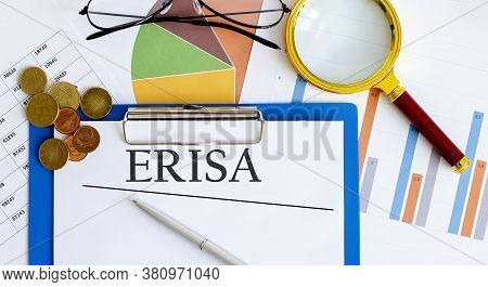 Paper With Employee Retirement Income Security Act Erisa On A Table With Charts , Coins