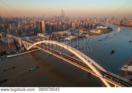 Shanghai Lupu Bridge aerial view over Huangpu River at sunset in China