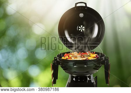 Barbecue Grill With Meat Products And Vegetables Outdoors On Sunny Day