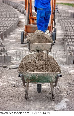 african workers operating a brick machine making fresh bricks