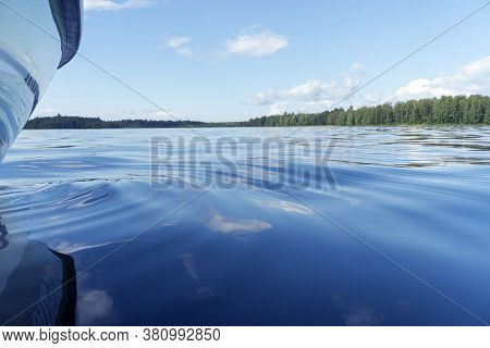 Side View Speeding Fishing Motor Boat With Drops Of Water. Blue Ocean Sea Water Wave Reflections Wit