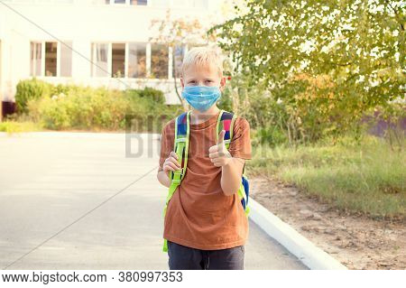 Back To School. School-age Boy With A Protective Medical Mask On Her On His Face With A School Backp