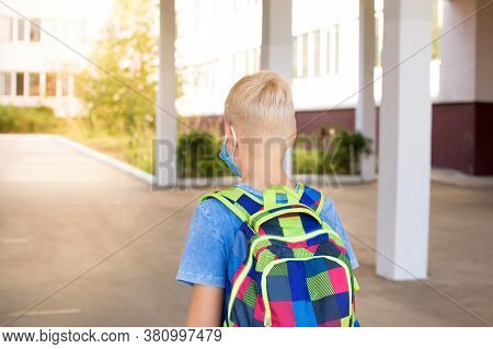 Back To School. School-age Boy With A Protective Medical Mask On Her On His Face With A School Backp