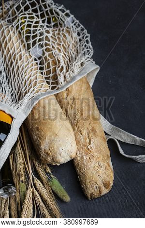 Homemade Italian Bread Baguette Stirato And A Bottle Of Wine In A Shopping Bag