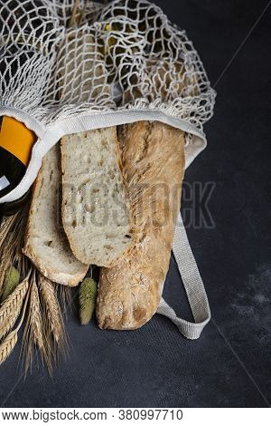 Homemade Italian Bread Baguette Stirato And A Bottle Of Wine In A Shopping Bag