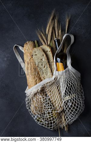 Homemade Italian Bread Baguette Stirato And A Bottle Of Wine In A Shopping Bag