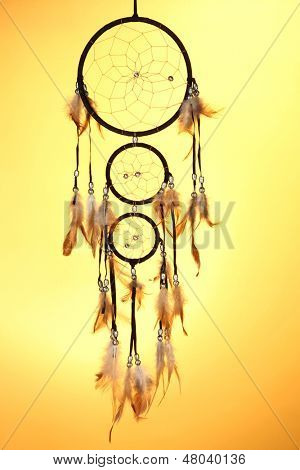 Beautiful dream catcher on yellow background