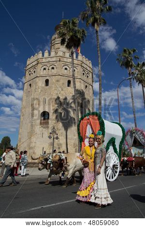 SEVILLE, SPAIN - MAY 16: The RomerÃ?ÃÂ­ia del RociÃ?ÃÂ­o pilgrimage passing by the Tower of Gold on May 16, 2013 in Seville, Spain. The Romeria del Rocio pilgrimage dates from the year 1653.