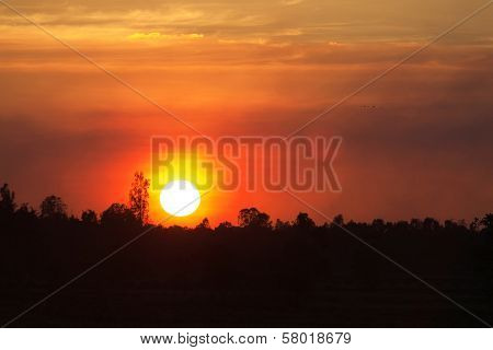 Sun Rays And Dark Clouds At Sunset