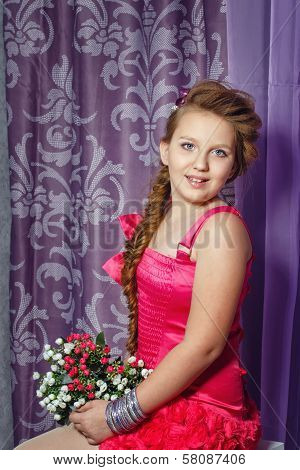 Little Girl In Pink Dress With Bouquet Of Flowers