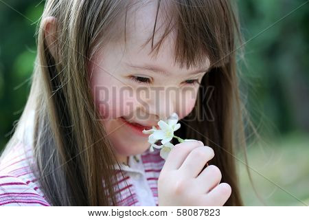 Portrait Of Beautiful Young Girl With Flowers In The Park