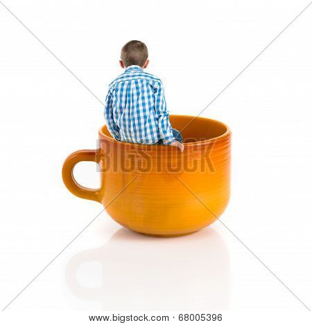 Kid Inside Ceramic Cup Over White Backgrpund