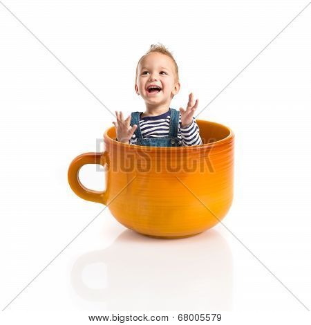 Kid Inside Ceramic Cup Over White Backgrpund