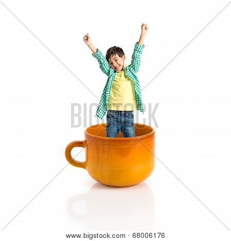 Kid Inside Ceramic Cup Over White Backgrpund