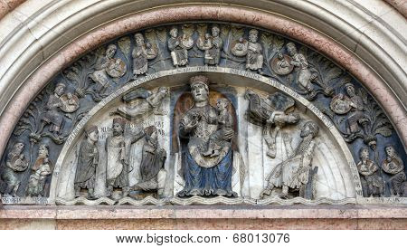 PARMA, ITALY - MAY 01, 2014: Virgin Mary with baby Jesus on the baptistery from Benedetto Antelami. Baptistery in Parma is considered to be among the most important Medieval monuments in Europe.
