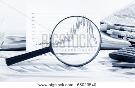 Business diagramme with magnifying glass, workplace businessman