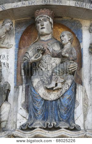 PARMA, ITALY - MAY 01, 2014: Virgin Mary with baby Jesus on the baptistery from Benedetto Antelami. Baptistery in Parma is considered to be among the most important Medieval monuments in Europe.