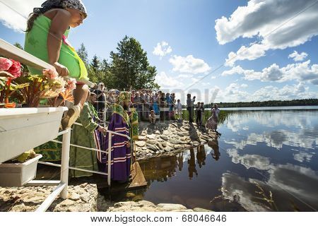 KRASNY BRONEVIK, RUSSIA - JULY 7, 2014: Celebrations commemorating the Rev. Anthony Dymsky (died 1224) in Antony Dymsky Monastery - Procession on Lake Dymsky, the great blessing of water and bathing.