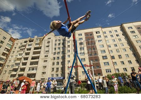 TIKHVIN, RUSSIA - JULY 7, 2014: Unidentified participants city competitions in Street workout timed to the celebration of the day of the city of Tikhvin.