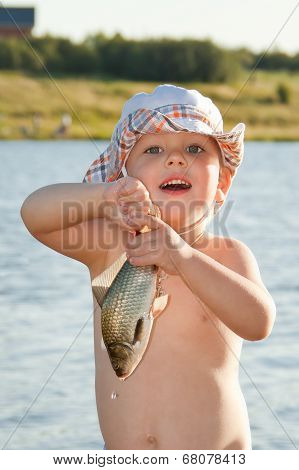 Little Boy Holding A Fish