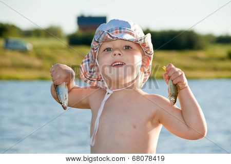 Boy Holding Two Small Fish