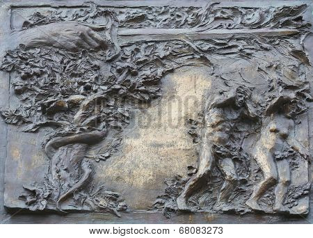 PORT AZZURRO, ITALY - MAY 03,2014: Adam and Eve, the expulsion from paradise, detail on the door of the church of St. James the Greater. The church is located inside the fort of the same name.