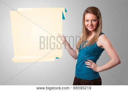 Baeutiful young woman holding white origami paper copy space