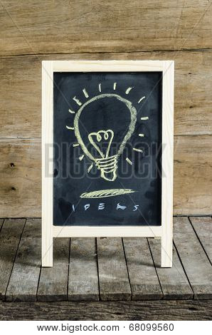 Light Blub Chalkboard Drawing on wooden background