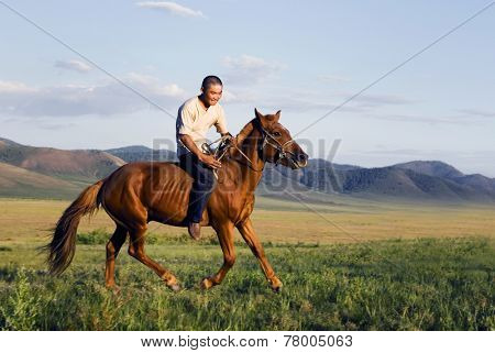 Young man riding a horse in a scenic view of nature.