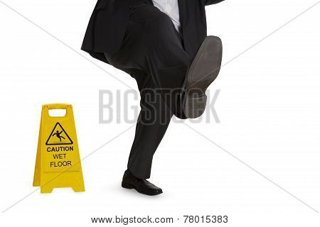 Man In Suit Slipping On Wet Floor